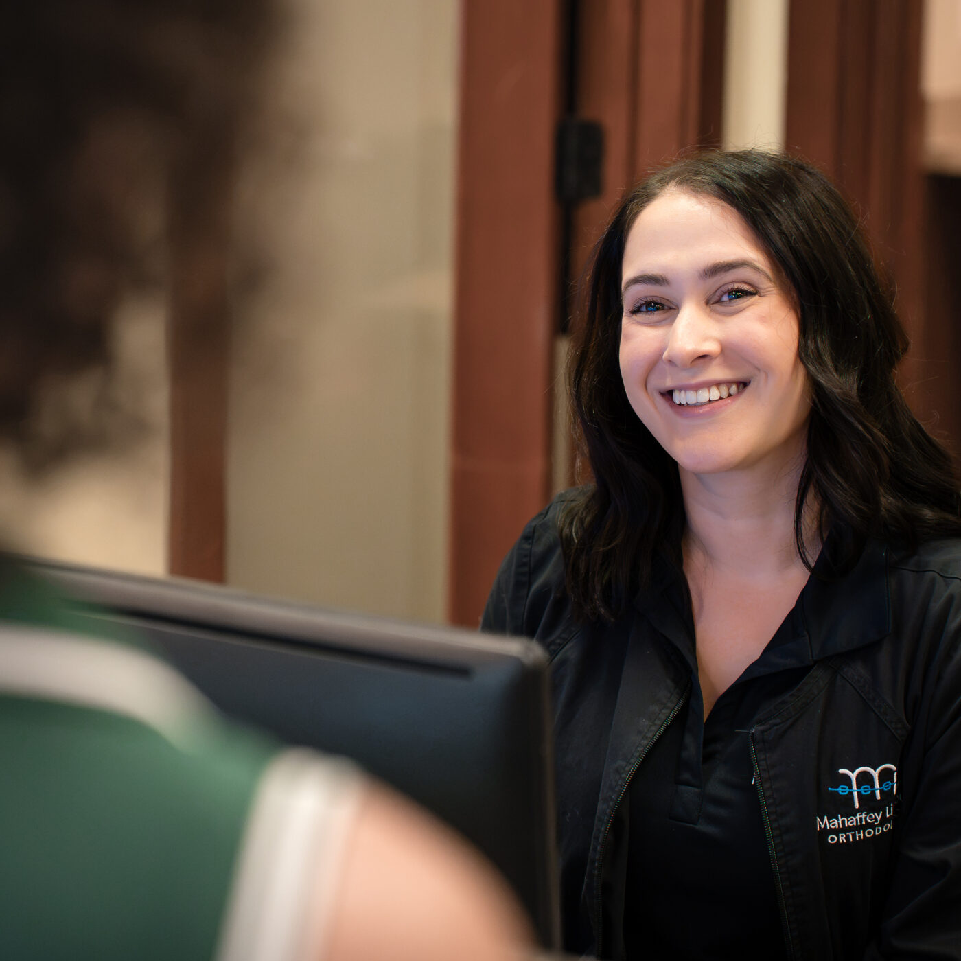 Smiling adult patient at Mahaffey & Linkous Orthodontics in Peachtree City, braces and orthodontic care.